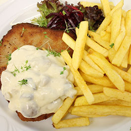 Ein Klassiker ist das saftige Schweineschnitzel mit knusprigen Pommes und cremig-würziger Jägersauce 